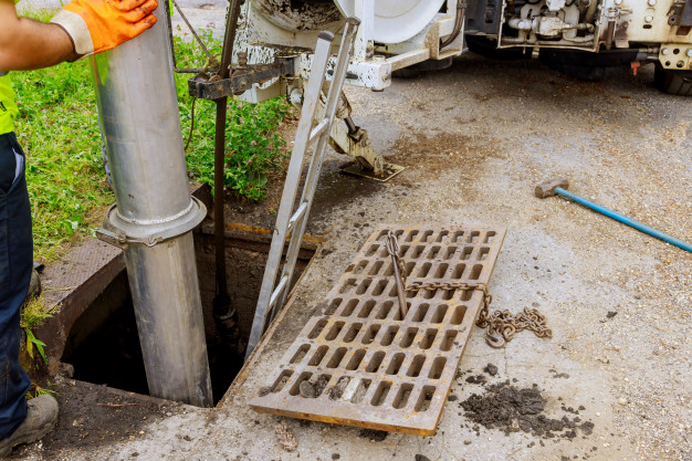 A sewage cleaning truck unblocking a sewerage line